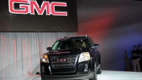 A black GMC Terrain on display at an auto show