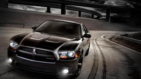 A used 2012 Dodge Charger Blacktop flashes its lights.