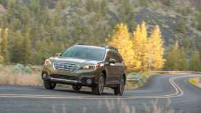 A 2015 Subaru Outback in the fall foliage