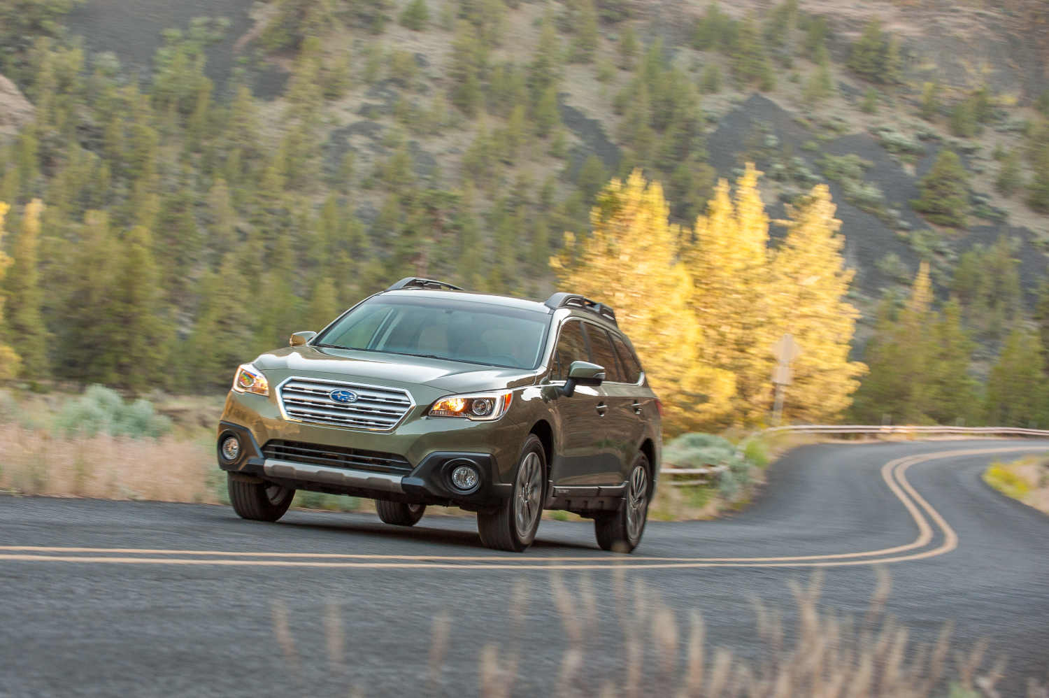 A 2015 Subaru Outback in the fall foliage