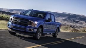 The 2018 Ford F-150 driving on a road in the wilderness