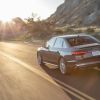 A rear view of the 2020 Audi S4 driving down the road.