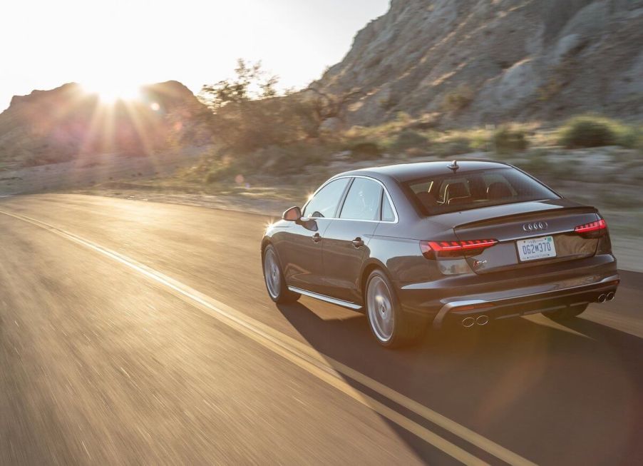 A rear view of the 2020 Audi S4 driving down the road.