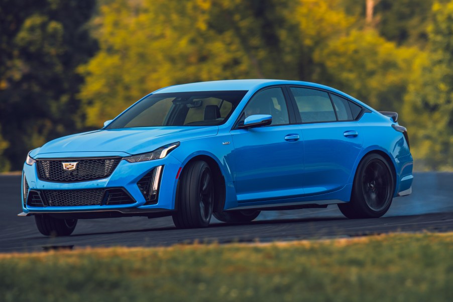 A blue Cadillac CT5 V Blackwing sliding at a racetrack