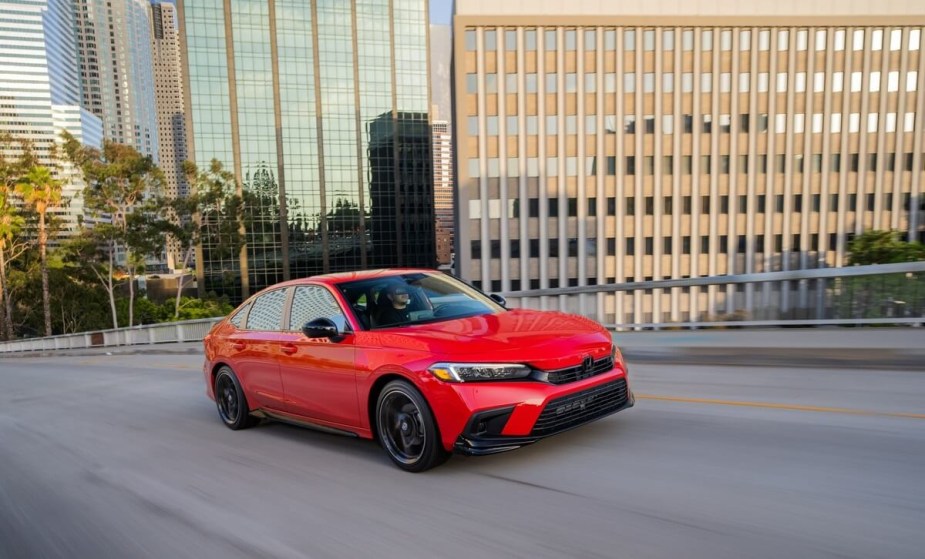 A 2023 Honda Civic shows off its front-end styling as it drives city streets.