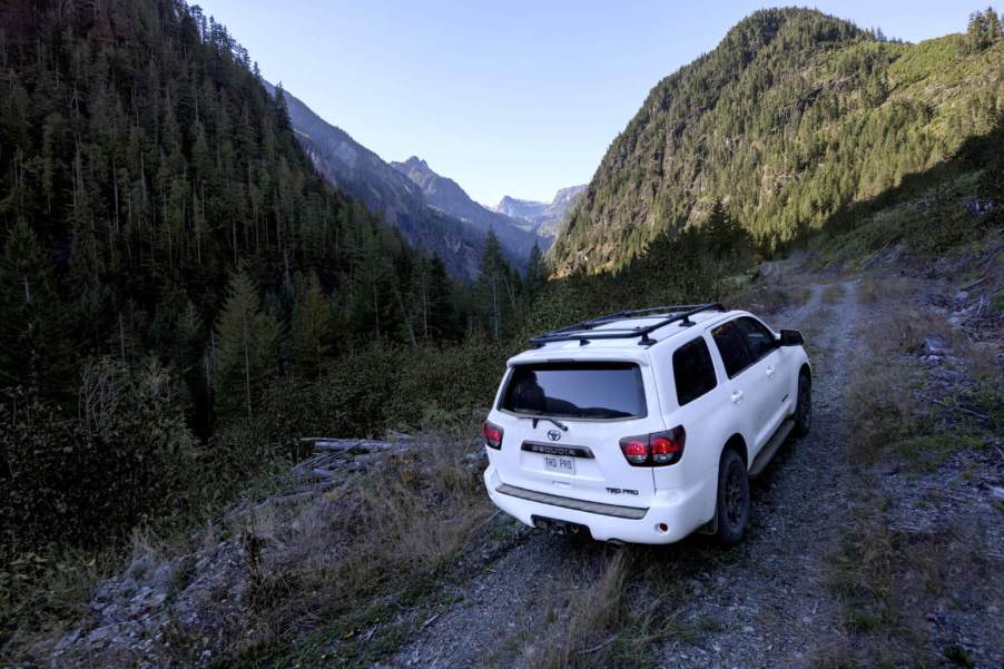 A white 2022 Toyota Sequoia TRD Pro, the last with a V8 engine, scales a mountain trail.