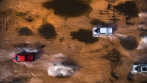 Three 2023 F-150 Raptor Rs mobbing through the desert