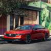 A red 2023 Honda Accord parked in front of a building.