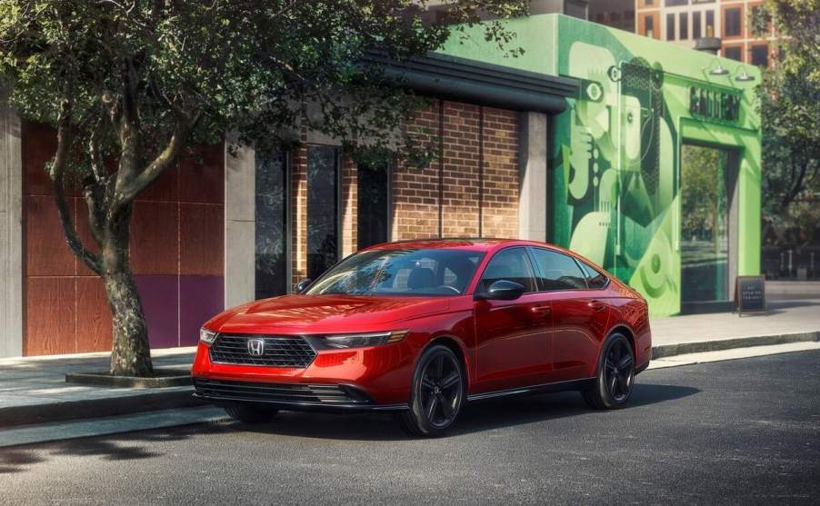 A red 2023 Honda Accord parked in front of a building.