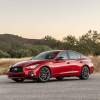 A red 2023 Infiniti Q50 parked on concrete in a mountainous area.