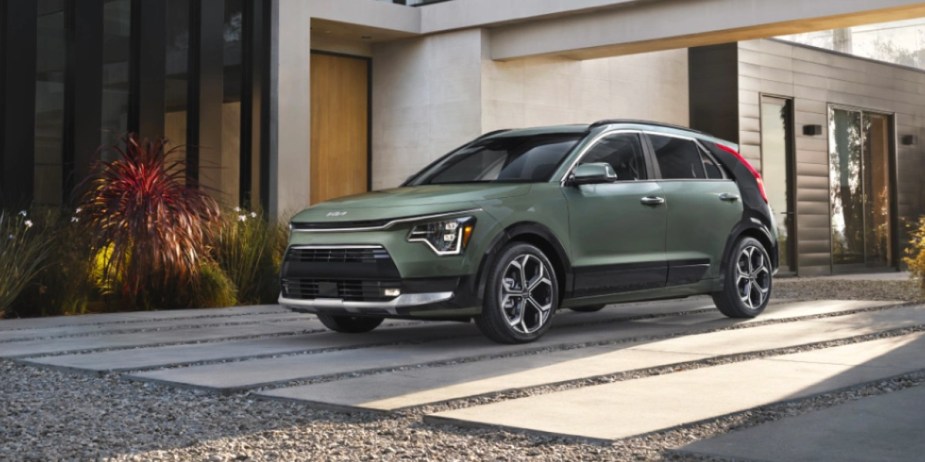 A green 2023 Kia Niro subcompact hybrid SUV is parked. 