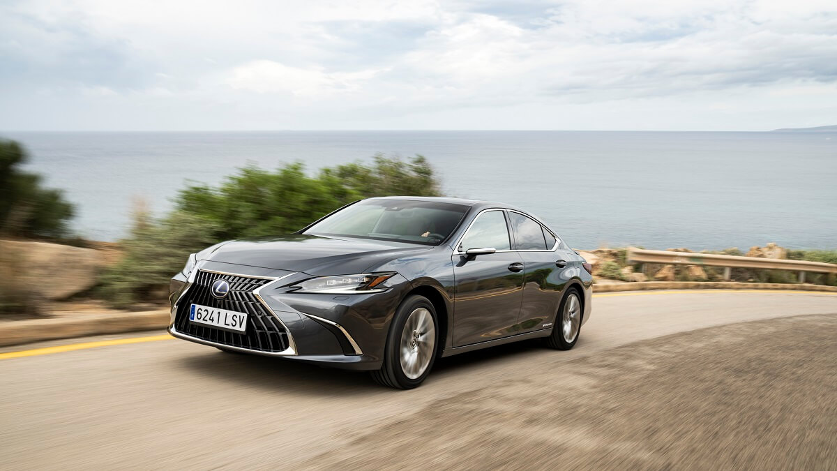 A gray 2023 Lexus ES 300h hybrid corners by the coast.