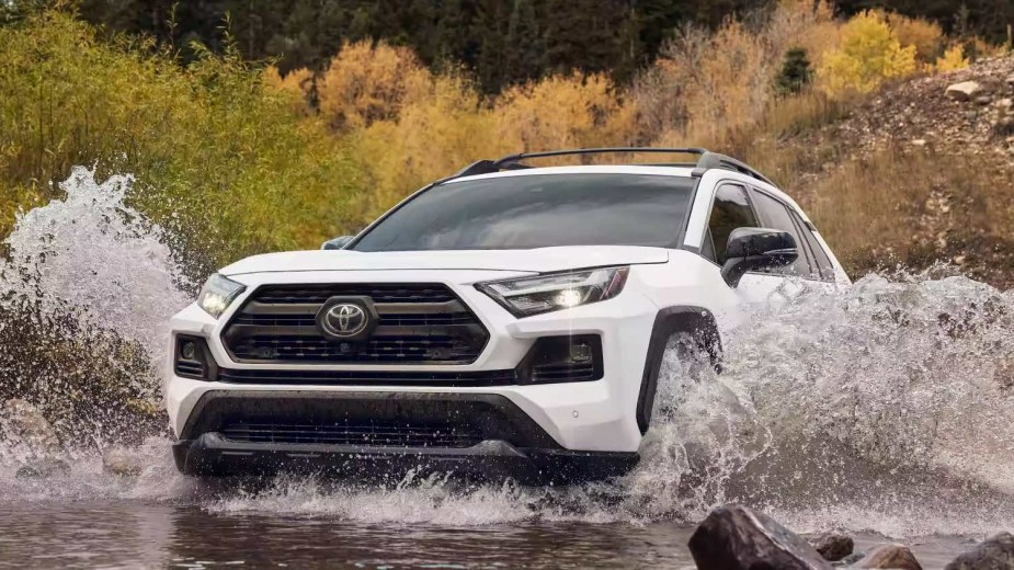 a white 2023 Toyota RAV4 in water beats the 2023 Volkswagen Tiguan 