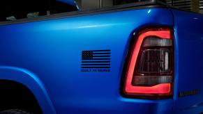 American flag painted on the blue bed of a Ram 1500 pickup truck.