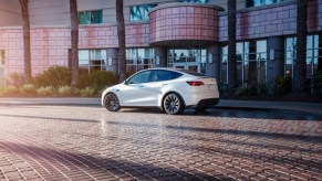 A white 2023 Tesla Model Y small electric SUV is parked.