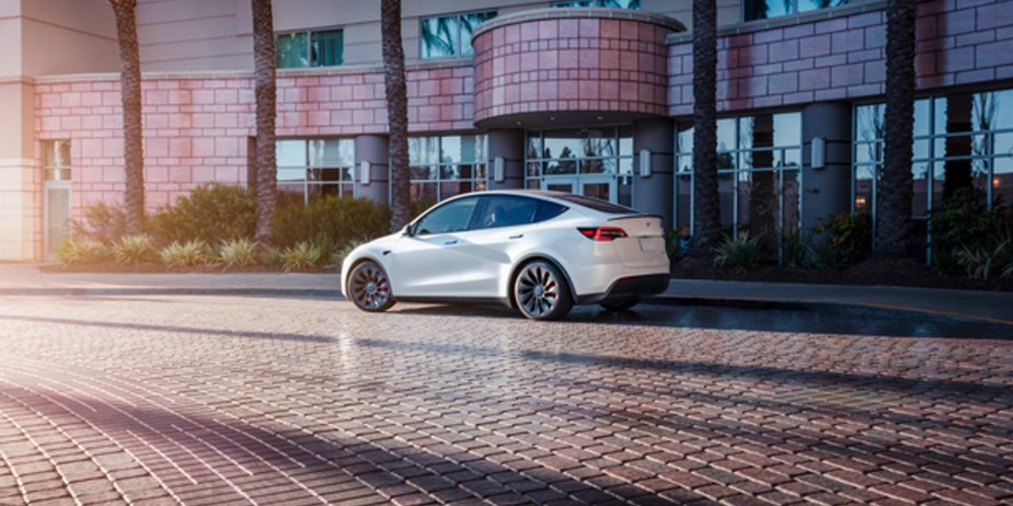 A white 2023 Tesla Model Y is parked. 