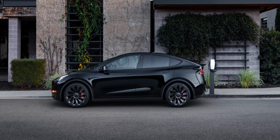 A black 2023 Tesla Model Y is parked. 