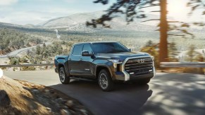 The 2023 Toyota Tundra driving up the road