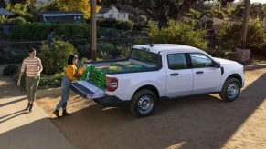 A white 2023 Ford Maverick has items loaded into its bed.