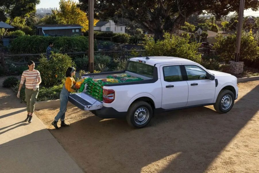 A white 2023 Ford Maverick has items loaded into its bed.