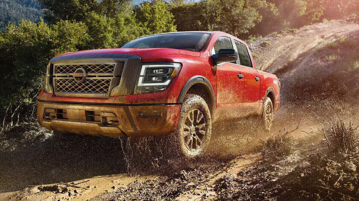 A 2023 Nissan Titan full-size truck drives off-road.