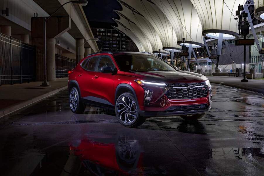 A red 2024 Chevrolet Trax parked in a covered area.