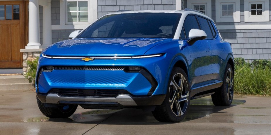 A blue 2024 Chevrolet Equinox small SUV is parked. 