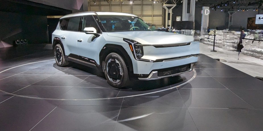 A blue 2024 Kia EV9 is parked at the 2023 New York International Auto Show. 