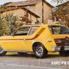 A yellow AMC Gremlin shown on a postcard.