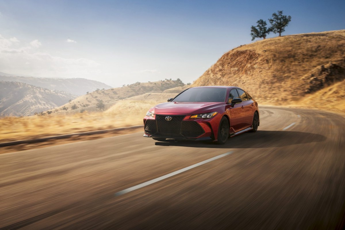 A red 2020 TRD Toyota Avalon on a mountain road