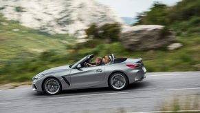 A silver BMW Z4 M40i corners on a mountain road.