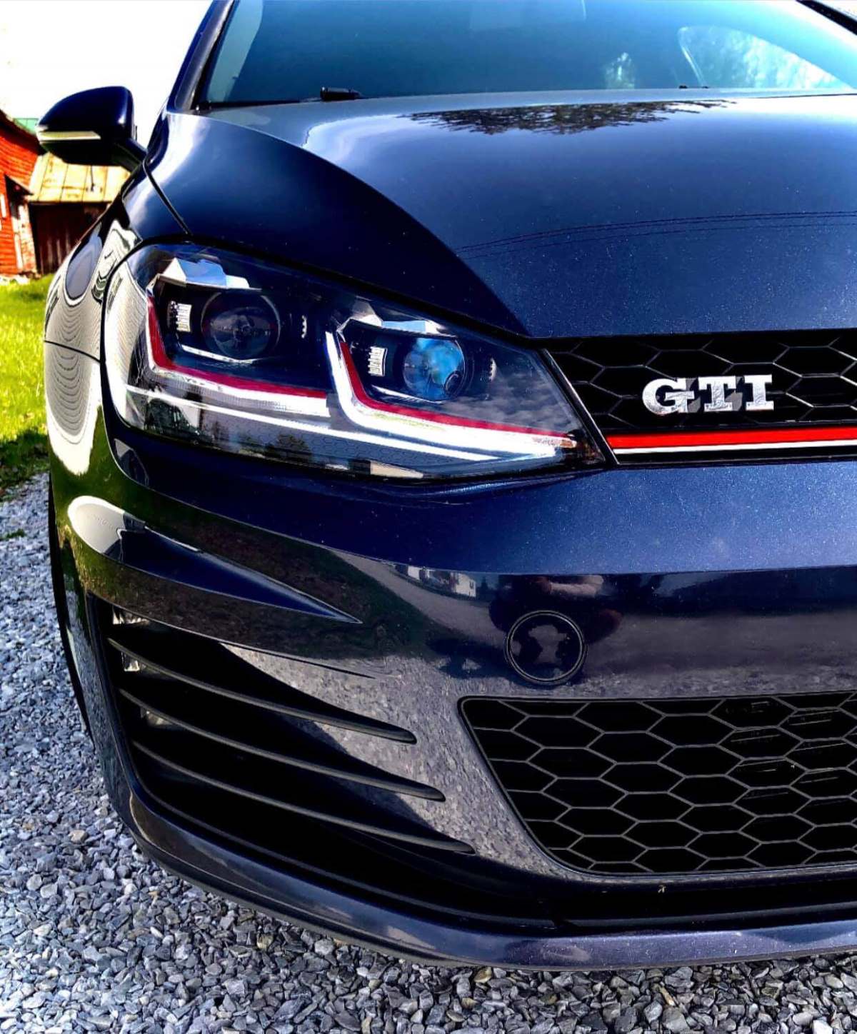 Tight shot of the chrome GTI badge on a blue 2017 model