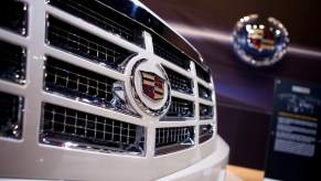 A close up of a white Cadillac Escalade on the grille with the logo displayed.