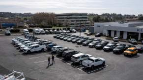 A new car lot, where mechanics could recommend used over new cars, with many options parked across the lot.