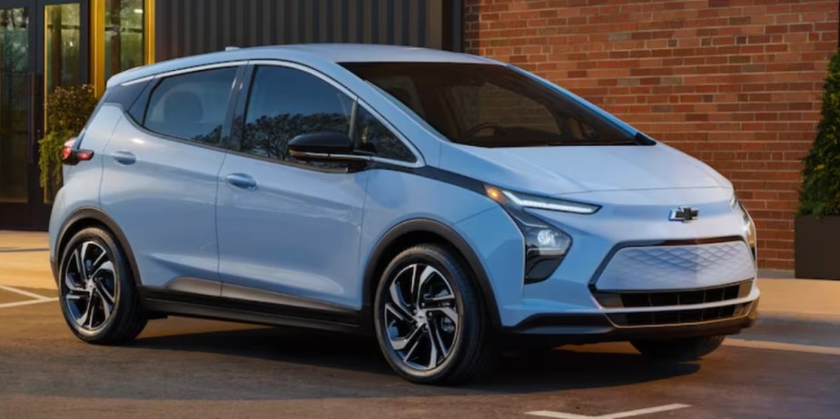 A blue 2023 Chevrolet Bolt EV small electric hatchback is parked. 