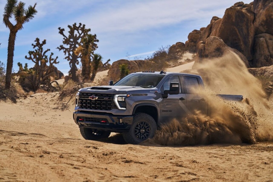 A 2024 Chevy Silverado 2500HD ZR2 heavy-duty truck drives off-road.