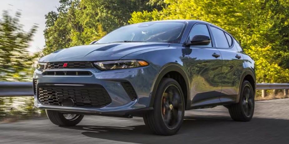 A blue 2023 Dodge Hornet small SUV is driving . 