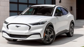 A white 2023 Ford Mustang Mach-E small electric SUV is parked.