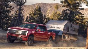 The Ford F-150 Lightning tows a trailer. With Pro Trailer Hitch Assist, it can actually help automatically hitch a trailer.