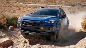 Front angle view of blue 2024 Subaru Crosstrek Wilderness crossover SUV