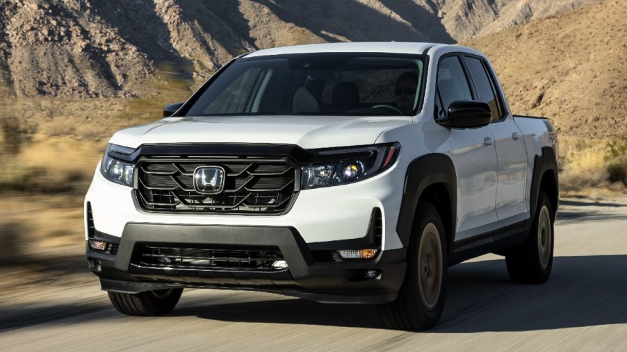 Front angle view of white 2023 Honda Ridgeline midsize pickup truck