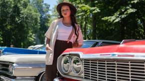 A young woman attends a car meet