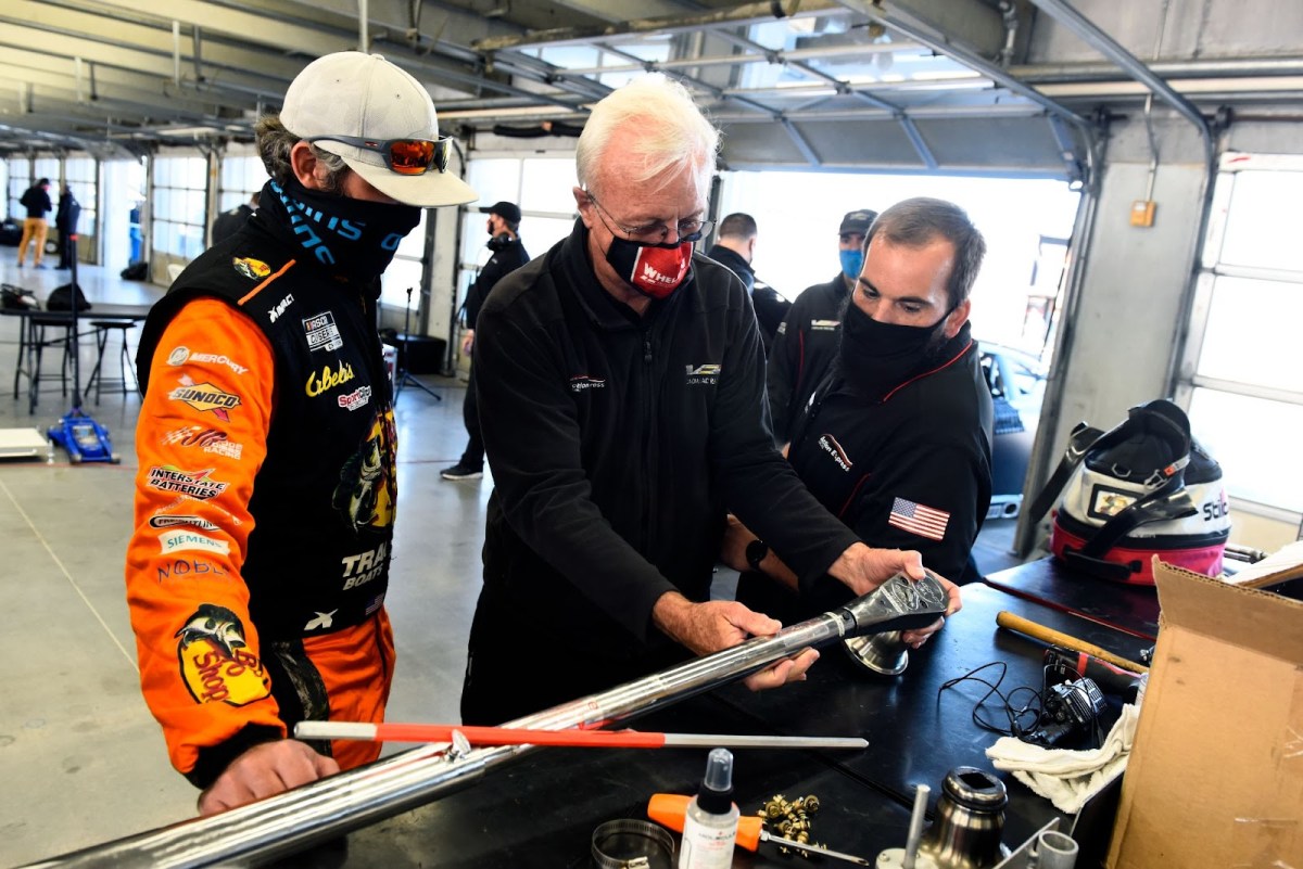 Mechanics working with a large breaker bar