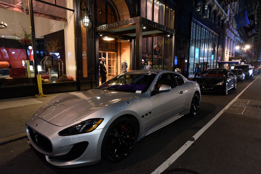 A silver Maserati GrandTourismo parked on a dark street