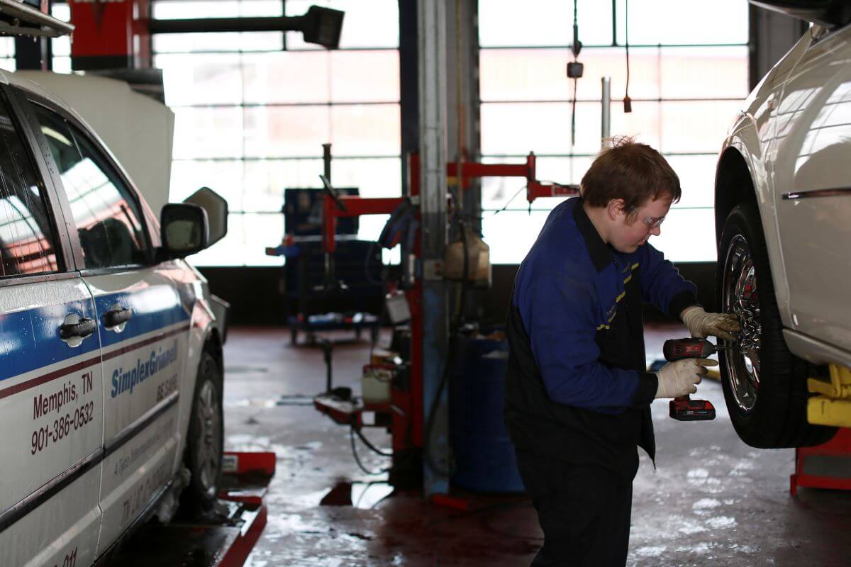 A service technician rotating tires on a customer's vehicle at a Goodyear service center in Millington, Tennessee