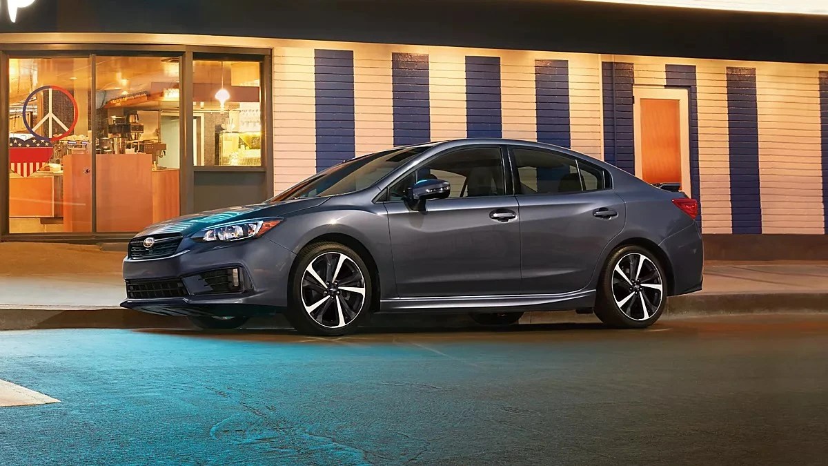 Gray 2023 Subaru Impreza compact car parked by a curb