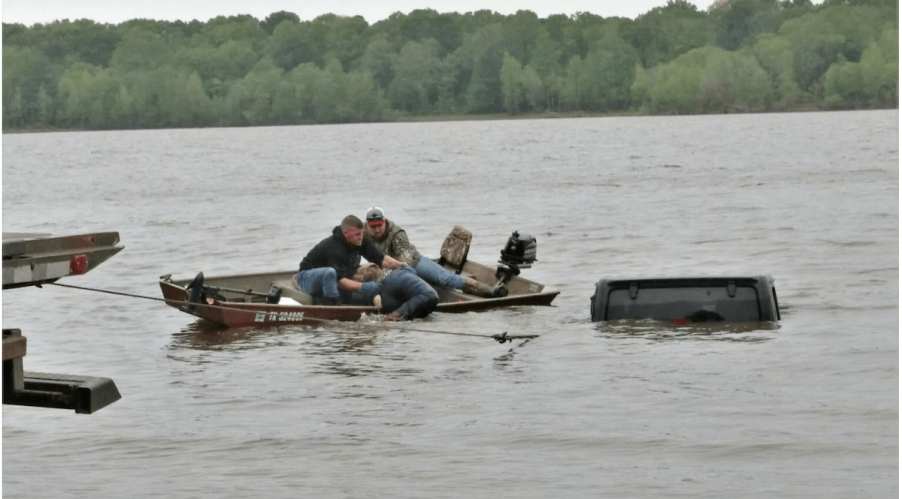 The roof of a Jeep Wrangler sticking up from the water of a Texas lake.