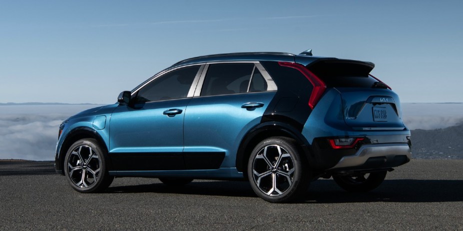 A blue 2023 Kia Niro Plug-In Hybrid subcompact PHEV SUV is parked. 