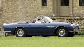 King Charles III drving his blue Aston Martin DB6