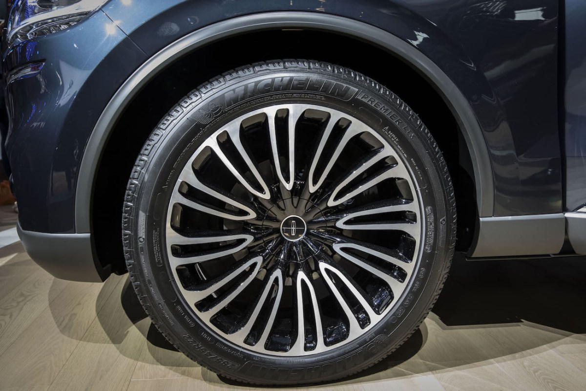 The Ford Motor Co. logo sits on the wheel hub of a Lincoln Aviator sports utility vehicle (SUV) as it stands on display at the Beijing International Automotive Exhibition in Beijing, China